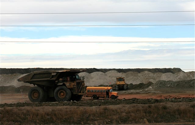고령의 운전자가 운전석에 앉아 사이드미러를 바라보는 모습